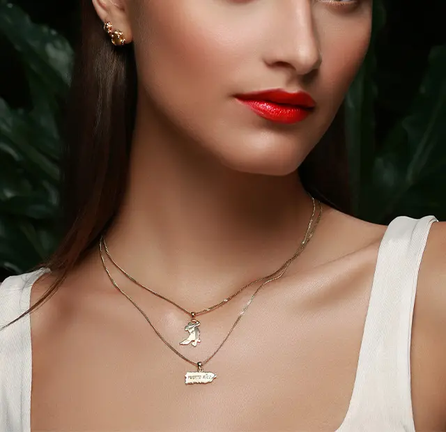 Woman wearing Coquí gold dancer and Puerto Rico necklaces.